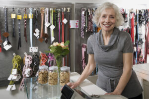 A practice owner standing in the lobby with pet merchandise behind her 
