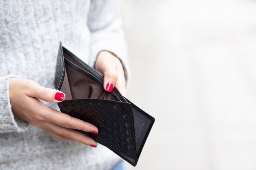 A person holding an empty wallet open